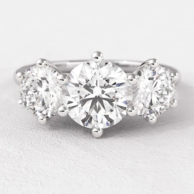 Vintage style 6 claw trilogy engagement ring on hand tr1058 from Bespoke Diamonds
