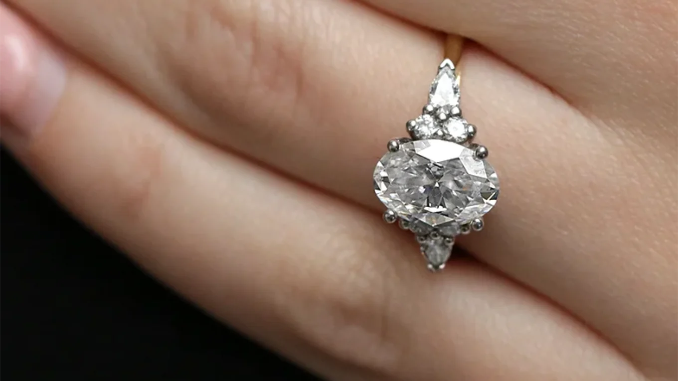 Oval engagement ring with pear and round side diamonds on hand TR1008-1