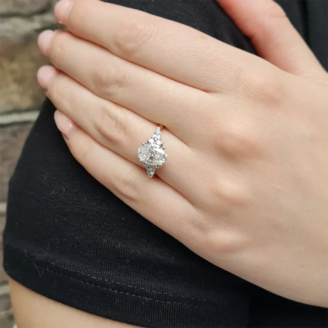 Oval engagement ring with pear and round side diamonds on hand TR1008-2