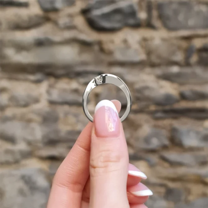 Twist style trilogy engagement ring in white gold side view on hand TR1009