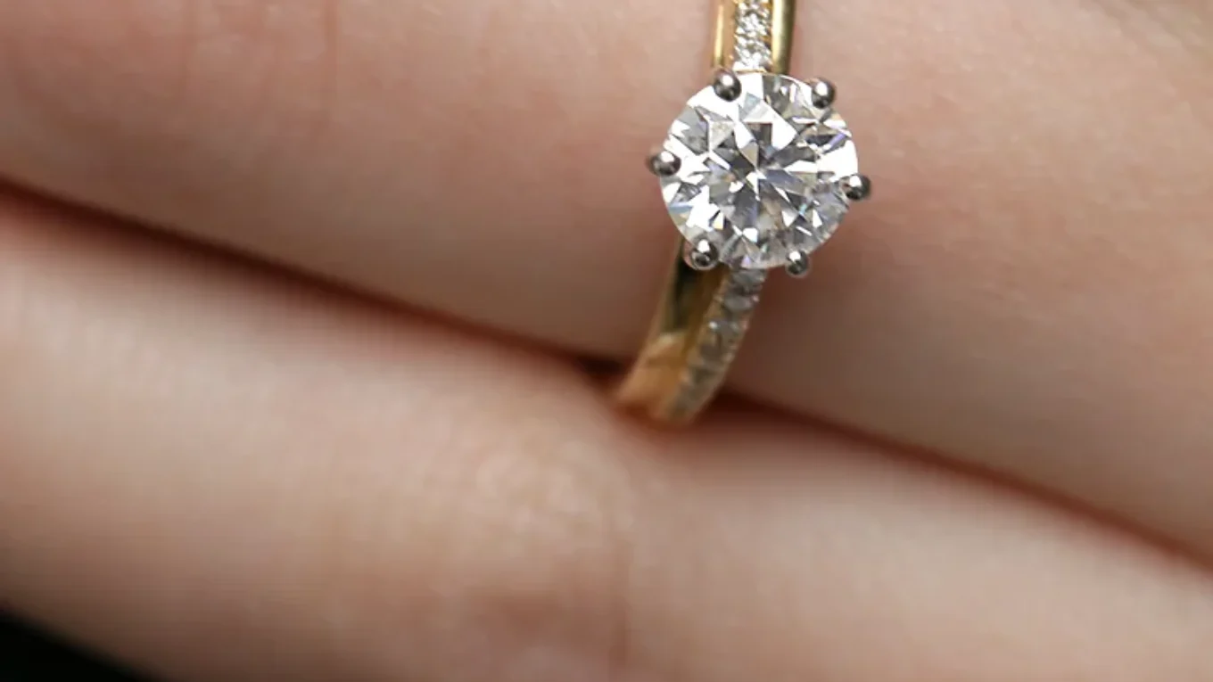 Unusual Claw Set Side Stone Ring on hand in yellow gold PR1021-1