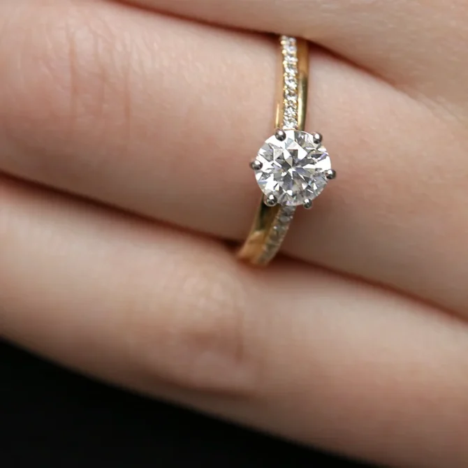 Unusual Claw Set Side Stone Ring on hand in yellow gold PR1021-1