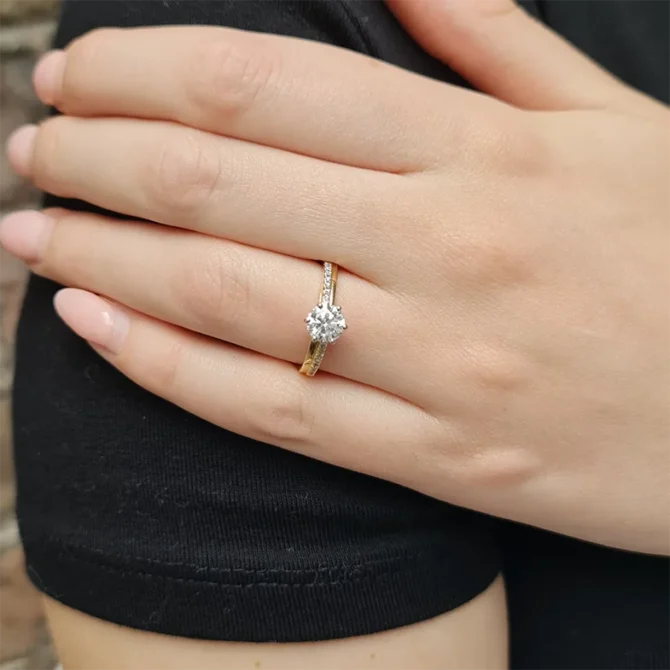 Unusual Claw Set Side Stone Ring on hand in yellow gold PR1021-2