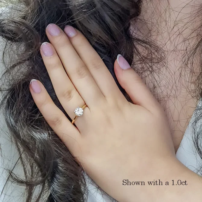 1.0ct round brilliant cut diamond engagement ring on hand image 3