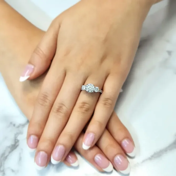 Claw set diamond three stone engagement ring on hand-tr1057-1