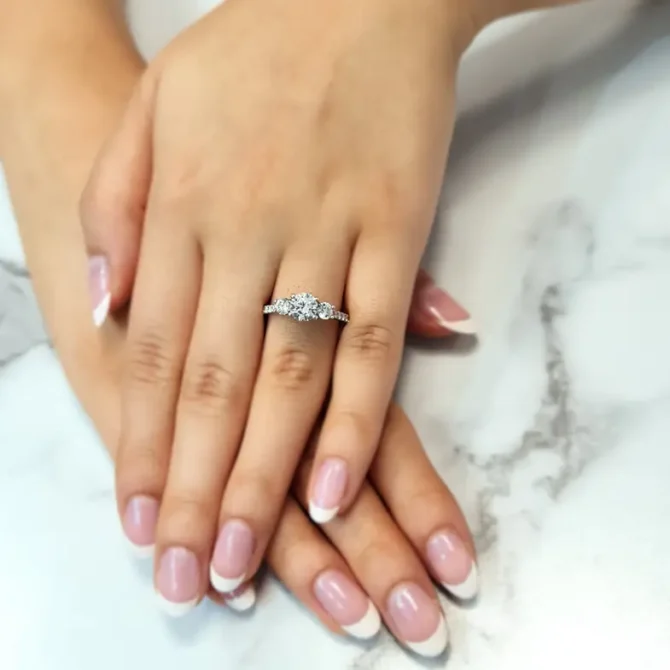 Claw set trilogy engagement ring on hand-tr1062-1