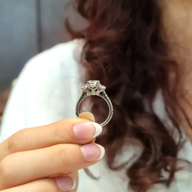 Claw set trilogy engagement ring on hand-tr1062-4