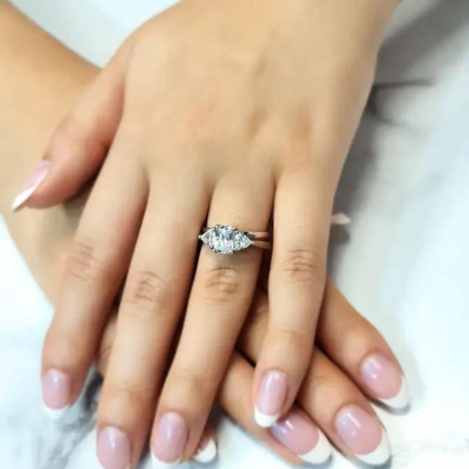 Radiant and trillion cut diamond ring with wedding ring on hand-tr1065-1
