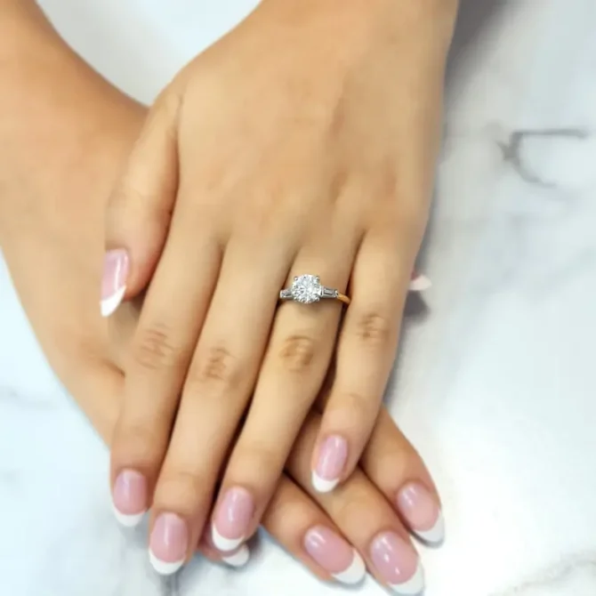 Round and tapered baguette cut three stone ring on hand tr1032 made by Bespoke Diamonds Ireland