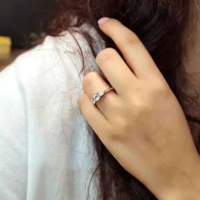 Yellow gold channel set trilogy diamond ring on hand-tr1074-2