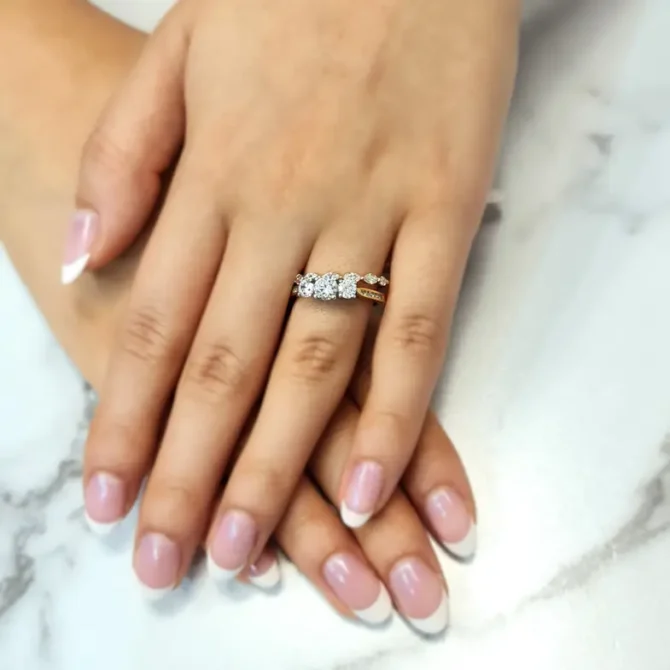 Yellow gold channel set trilogy diamond ring on hand-tr1074-5