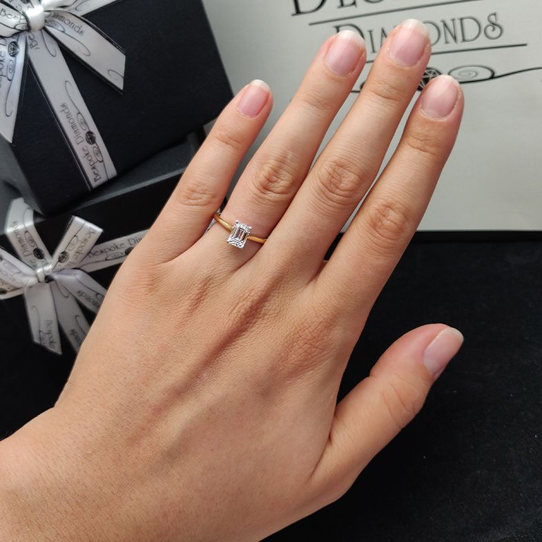 yellow-gold-emerald-cut-diamond-solitaire-engagement-ring-on-hand-sr1045-image-1