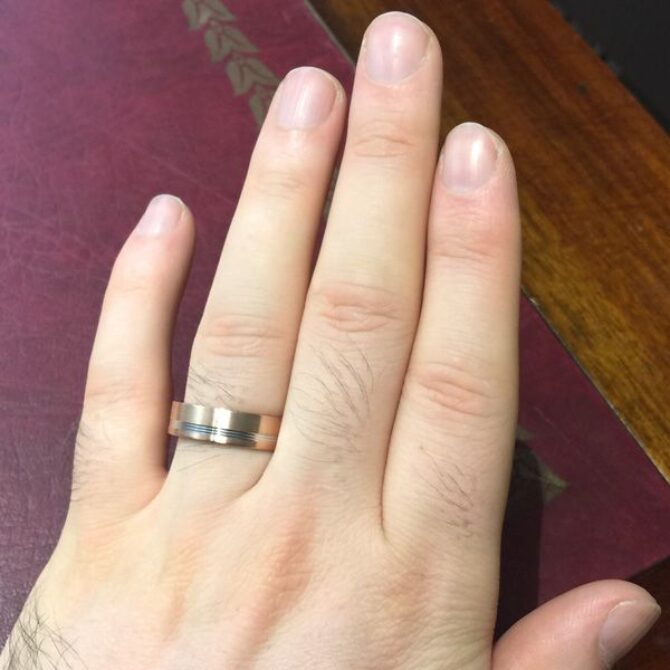 Rose gold and palladium gents wedding band hand image