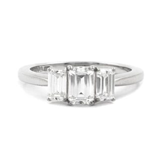 Emerald cut bespoke designed trilogy diamond engagement ring