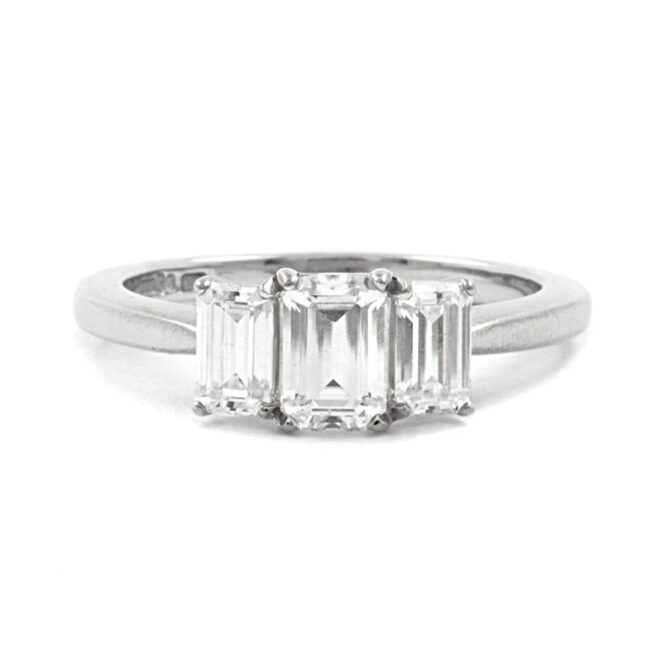 Emerald cut bespoke designed trilogy diamond engagement ring