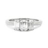 Emerald cut bespoke designed trilogy diamond engagement ring