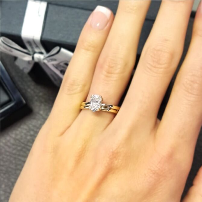 SR1050-oval-cut-lab-grown-diamond-solitaire-engagement-ring-with-wedding-ring-on-hand-image-2