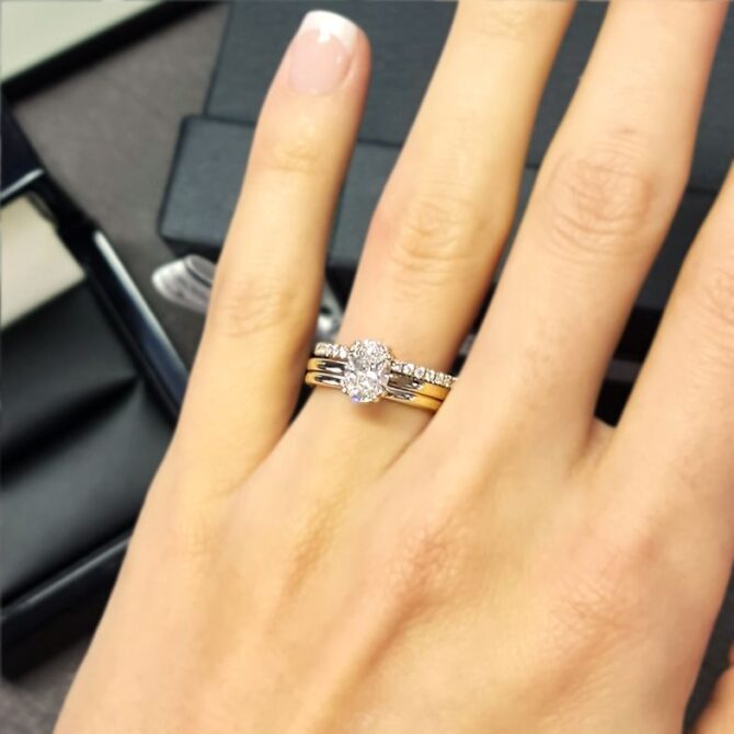 SR1050-oval-cut-lab-grown-diamond-solitaire-engagement-ring-with-wedding-ring-on-hand-image-3