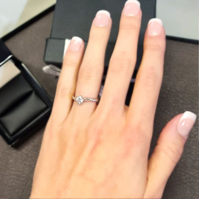 pr1024-twist-style-side-stone-diamond-engagement-ring-on-hand-image-1