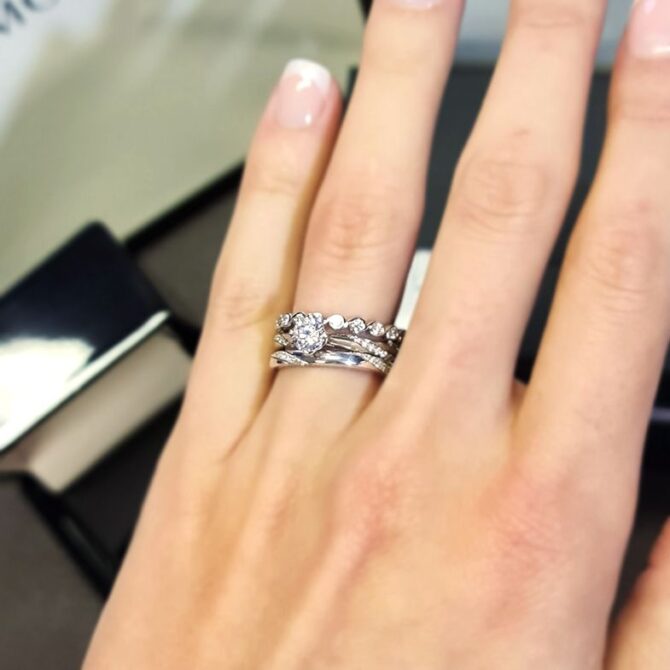 pr1024-twist-style-side-stone-diamond-engagement-ring-with-wedding-ring-on-hand-image-3