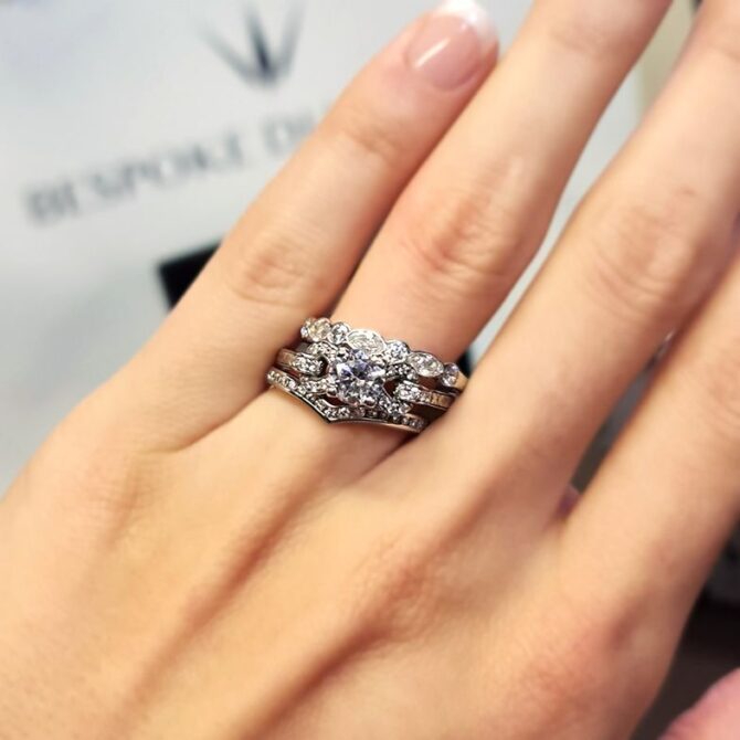 pr1047-18k-white-gold-side-stone-diamond-engagement-ring-on-hand-image-1