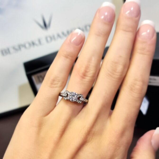 pr1047-18k-white-gold-side-stone-diamond-engagement-ring-on-hand-image-2