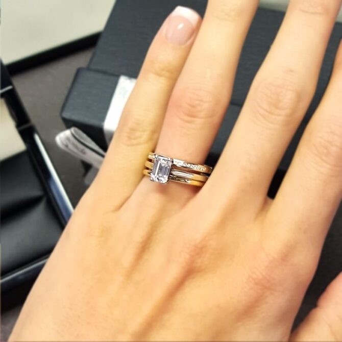 sr1045-emerald-cut-diamond-solitaire-engagement-ring-with-wedding-ring-on-hand-image-3