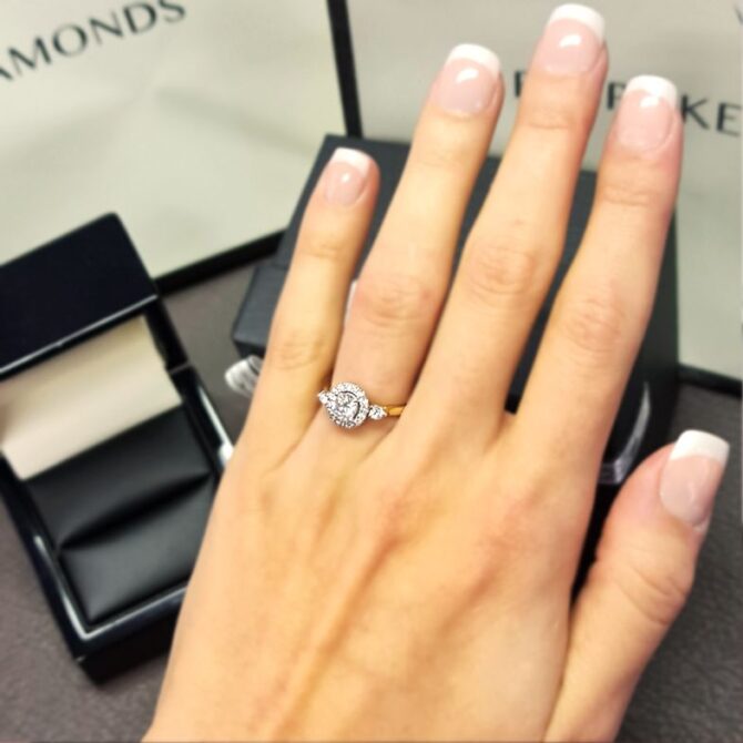 vr1066-18k-yellow-gold-round-cut-diamond-halo-engagement-ring-on-hand-image-1