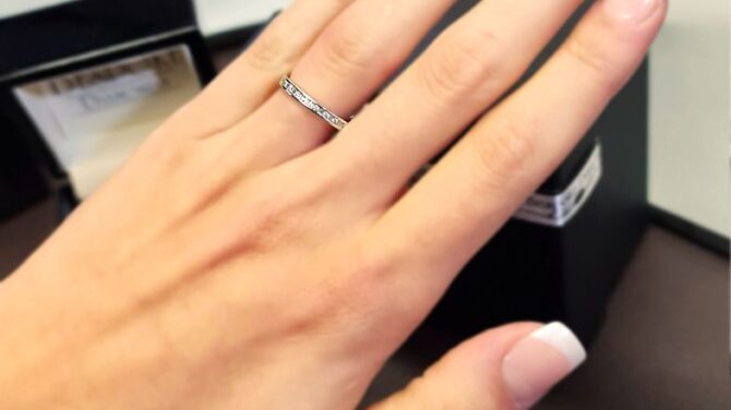 wr2029-white-gold-channel-set-ladies-diamond-wedding-ring-on-hand-image-1