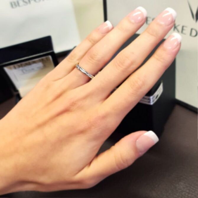 wr2029-white-gold-channel-set-ladies-diamond-wedding-ring-on-hand-image-1