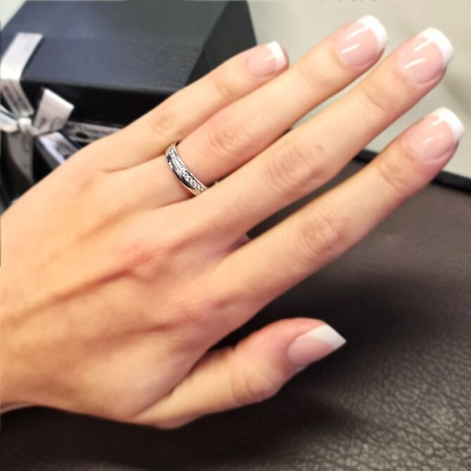 wr2038-white-gold-channel-set-ladies-diamond-wedding-ring-on-hand-image-1