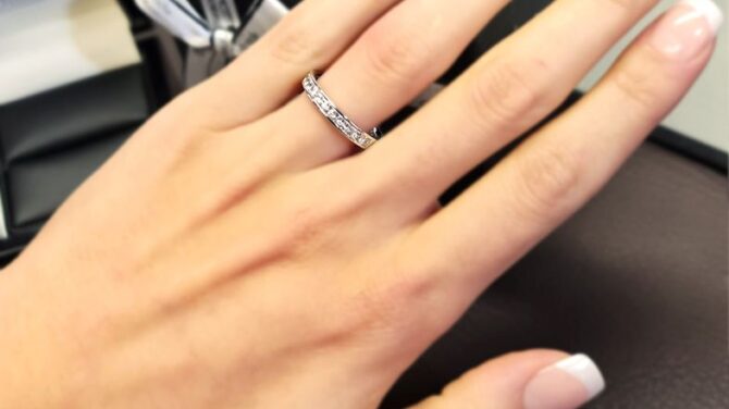 wr2059-white-gold-channel-set-ladies-diamond-wedding-ring-on-hand-image-1