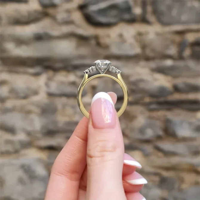Round and baguette unusual diamond engagement ring in yellow gold side view pr1070