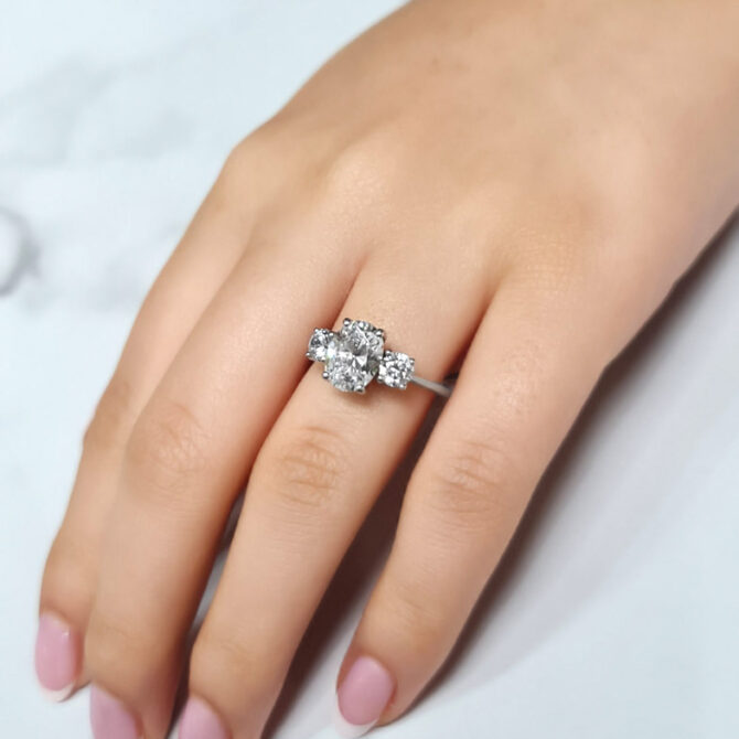 three stone oval and round cut diamond on hand-tr1028-6