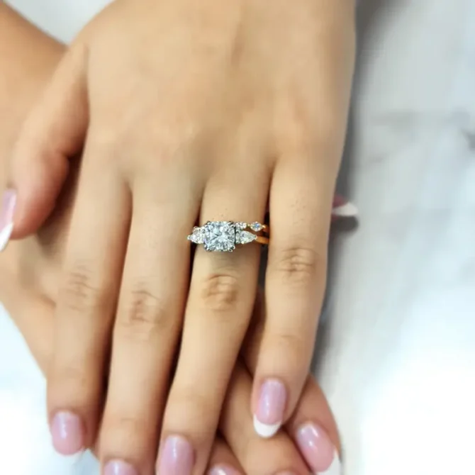 cushion cut and pear cut diamond trilogy engagement ring in yellow gold on hand tr1045 from Dublin, Ireland