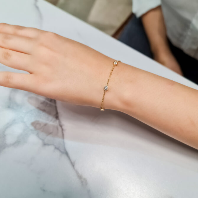 0.50ct 18k Yellow Gold Lab Grown Diamond Bracelet BBR016 worn on wrist on table 2