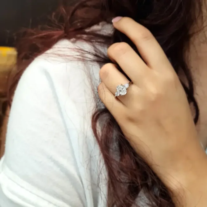 Oval three stone diamond ring on hand in white gold-tr1006-5