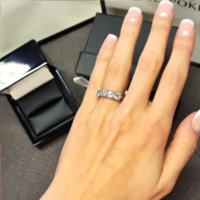 4 Stone Eternity Ring Swooping and Individual Claws on hand