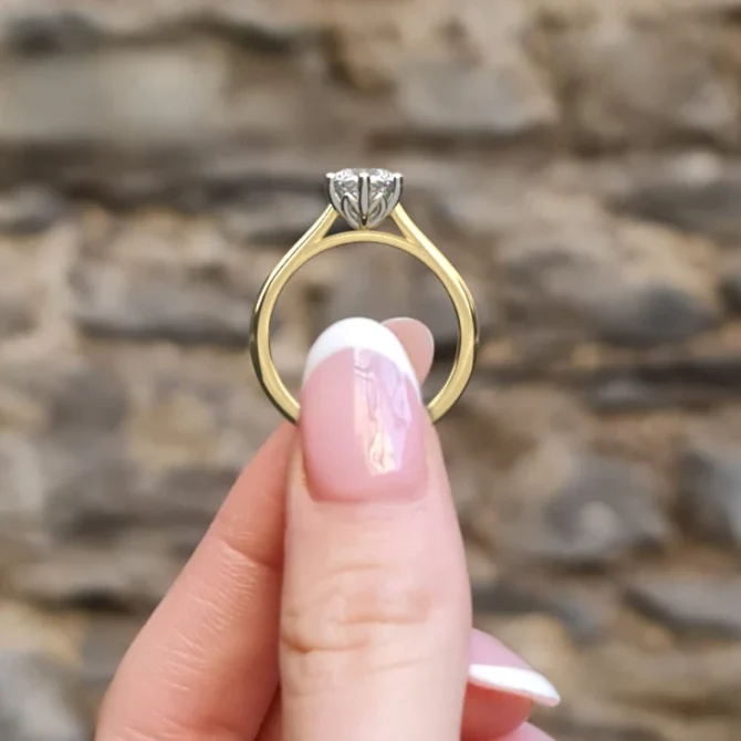 6 claw diamond solitaire engagement sr1025 1ct in yellow gold side view in hand