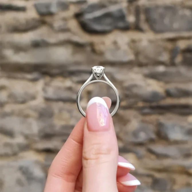 Pear cut solitaire diamond engagement ring sr1094 1.5ct in white gold side view in hand