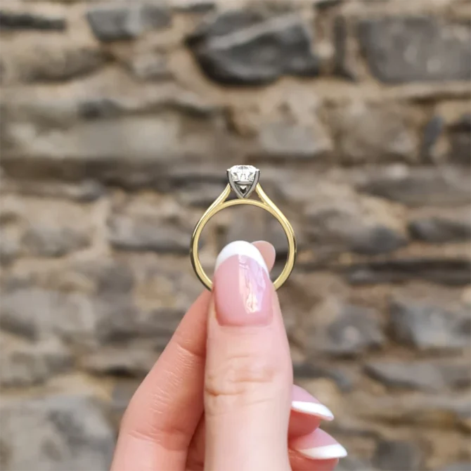 Pear cut solitaire diamond engagement ring sr1094 1.5ct in yellow gold side view in hand