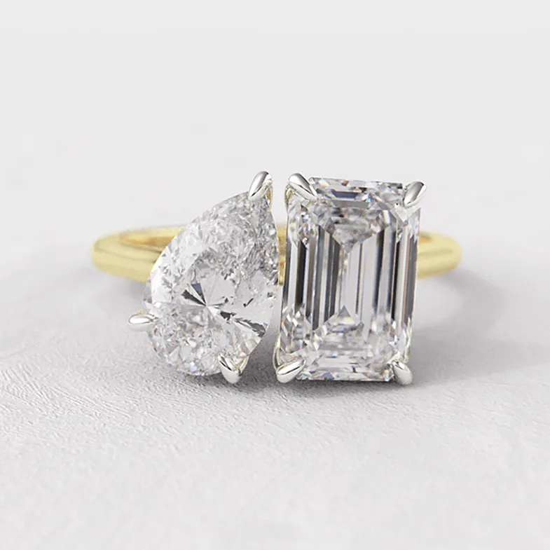 Toi Et Moi engagement ring with pear and emerald cut diamonds in yellow gold.webp