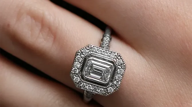 Vintage style emerald diamond halo engagement ring on hand vr1107