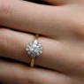 Vintage style oval halo and pear trilogy style engagement ring on hand vr1118