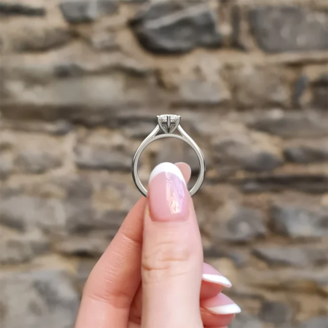 Marquise solitaire diamond engagement ring side view sr1098 in white gold in hand