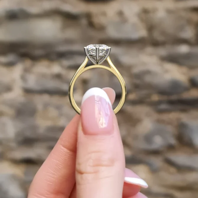 Side view solitaire diamond engagement ring in hand sr1056 9mm in yellow gold