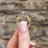 cushion stepping stone engagement ring in yellow gold pr1078 side view in hand