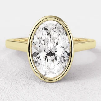Oval bezel set diamond engagement ring in yellow gold sr1023